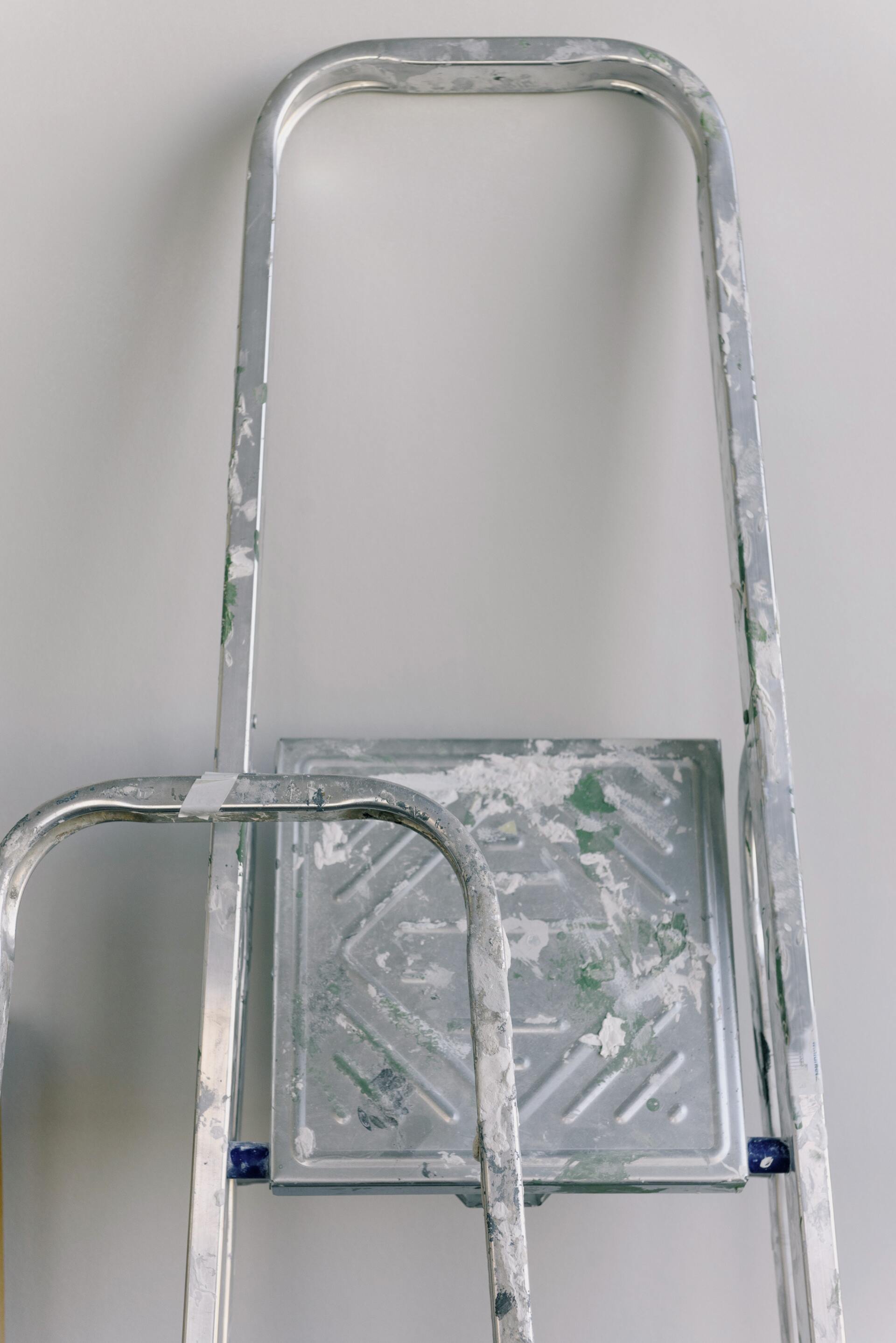 Metal folding cart with tall silver handle and platform on a white background